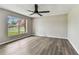 This bedroom features hard surface flooring and a ceiling fan at 102 Shore E Dr, Oldsmar, FL 34677