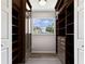 Spacious walk-in closet with built-in shelving and drawers, plus a large window at 102 Shore E Dr, Oldsmar, FL 34677