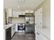 Modern kitchen with white cabinets, stainless steel appliances, and sleek countertops, ideal for cooking and entertaining at 102 Shore E Dr, Oldsmar, FL 34677