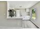 Open concept kitchen with white cabinetry, island seating, and a view of the yard at 102 Shore E Dr, Oldsmar, FL 34677
