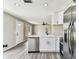 Bright kitchen featuring stainless steel appliances, white cabinets, and modern finishes at 102 Shore E Dr, Oldsmar, FL 34677