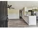 Living room leading into kitchen featuring gray flooring and neutral walls at 102 Shore E Dr, Oldsmar, FL 34677