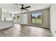 Open-concept living room featuring neutral walls, natural light, and a kitchen view at 102 Shore E Dr, Oldsmar, FL 34677