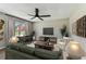 Comfortable living room featuring contemporary furniture, a ceiling fan, and plenty of natural light at 102 Shore E Dr, Oldsmar, FL 34677