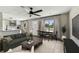 Bright living room with an open kitchen, stylish furniture, and a ceiling fan, perfect for relaxation at 102 Shore E Dr, Oldsmar, FL 34677