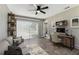 Living room featuring a gray couch and desk with an outdoor view at 102 Shore E Dr, Oldsmar, FL 34677