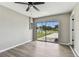 The bright living room has a ceiling fan, light gray walls, and sliding glass door providing lots of natural light at 102 Shore E Dr, Oldsmar, FL 34677