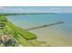 Picturesque view of the pier extending into the beautiful waters, perfect for sunset strolls at 102 Shore E Dr, Oldsmar, FL 34677