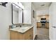 Bathroom with granite countertop, single sink and view of kitchen at 11605 Gulf Blvd # 502, Treasure Island, FL 33706