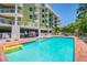 Inviting community pool with surrounding lounge chairs at 11605 Gulf Blvd # 502, Treasure Island, FL 33706