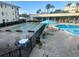 Community pool area featuring shuffleboard and ample seating at 1235 S Highland Ave # 2-206, Clearwater, FL 33756