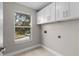 Laundry room with white cabinets and window at 13222 Pike Lake Dr, Riverview, FL 33579