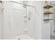 White tiled shower with sliding glass door and built-in shelves at 2454 Knight Island Dr, Brandon, FL 33511