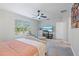 Spacious bedroom with king-size bed, TV, and ceiling fan at 30399 Marquette Ave, Wesley Chapel, FL 33545