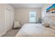 Bright bedroom with king-size bed, plush chair, and large closet at 30399 Marquette Ave, Wesley Chapel, FL 33545