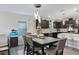 Kitchen and dining area with dark wood table and six chairs at 30399 Marquette Ave, Wesley Chapel, FL 33545