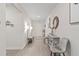 Bright and airy entryway with gray chairs and a bench at 30399 Marquette Ave, Wesley Chapel, FL 33545