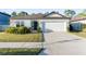 Single-story home with a two-car garage and well-manicured lawn at 30399 Marquette Ave, Wesley Chapel, FL 33545
