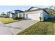 House exterior showcasing a white garage door and landscaping at 30399 Marquette Ave, Wesley Chapel, FL 33545