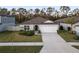 Single-story home with a two-car garage and front yard at 30399 Marquette Ave, Wesley Chapel, FL 33545