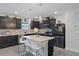 Modern kitchen featuring dark cabinets and a large island at 30399 Marquette Ave, Wesley Chapel, FL 33545