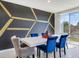 Modern dining area with white table and blue velvet chairs at 3146 Forrest Plum Ct, Zephyrhills, FL 33540