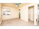 Empty bedroom with ceiling fan, window, and doorway to bathroom at 333 Bay Plz, Treasure Island, FL 33706