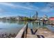 Wooden dock over the water with boats and buildings in the background at 333 Bay Plz, Treasure Island, FL 33706
