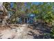 Quaint blue cottage nestled among trees with a stone pathway at 333 Bay Plz, Treasure Island, FL 33706