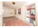 Living room with pink floor, multiple windows and doorway at 333 Bay Plz, Treasure Island, FL 33706