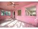 Pink sunroom with multiple windows, a ceiling fan, and tiled flooring at 333 Bay Plz, Treasure Island, FL 33706