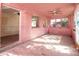 Pink sunroom featuring large windows, ceiling fan, and tiled floor at 333 Bay Plz, Treasure Island, FL 33706