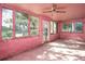 Bright pink sunroom with many windows, a ceiling fan, and tile floor at 333 Bay Plz, Treasure Island, FL 33706