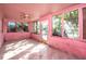 Pink sunroom with numerous windows, ceiling fan, and tiled floor at 333 Bay Plz, Treasure Island, FL 33706