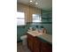 Bathroom with teal tile, vanity, and a toilet at 4464 36Th Ave N N Ave, St Petersburg, FL 33713