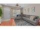 Living room with gray sectional sofa, wood floors, and a ceiling fan at 4508 Barnstead Dr, Riverview, FL 33578