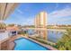 Relaxing pool view with canal and high-rise building in the background at 4973 58Th S Ave, St Petersburg, FL 33715