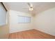 Empty bedroom with wood-look laminate flooring and a ceiling fan at 4987 Jonquil N Pl, Pinellas Park, FL 33782