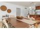 Elegant dining area with a wood table and neutral-toned chairs at 5558 Angelonia Ter, Land O Lakes, FL 34639