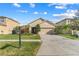 Two-story house with a two-car garage and manicured lawn at 5558 Angelonia Ter, Land O Lakes, FL 34639