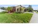 House exterior with palm trees, manicured lawn, and driveway at 5558 Angelonia Ter, Land O Lakes, FL 34639