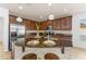 Modern kitchen with dark wood cabinets, granite counters, and stainless steel appliances at 5558 Angelonia Ter, Land O Lakes, FL 34639