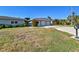 House exterior showcasing a three-car garage and a large driveway at 568 Johns Pass Ave, Madeira Beach, FL 33708