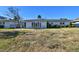 House exterior with a large yard and three-car garage at 568 Johns Pass Ave, Madeira Beach, FL 33708