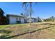 Side view of a light gray house with a well maintained lawn at 568 Johns Pass Ave, Madeira Beach, FL 33708