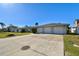 House exterior with a three-car garage and a large driveway at 568 Johns Pass Ave, Madeira Beach, FL 33708