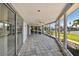 Enclosed porch with tile floor and access to backyard at 568 Johns Pass Ave, Madeira Beach, FL 33708