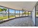 Bright screened porch overlooking the water, featuring tile floors at 568 Johns Pass Ave, Madeira Beach, FL 33708