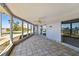 Spacious screened porch with tile flooring and water views at 568 Johns Pass Ave, Madeira Beach, FL 33708