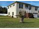 Two-story house with a large yard, attached garage, and a white fence at 7223 Morningstar Ln, New Port Richey, FL 34652